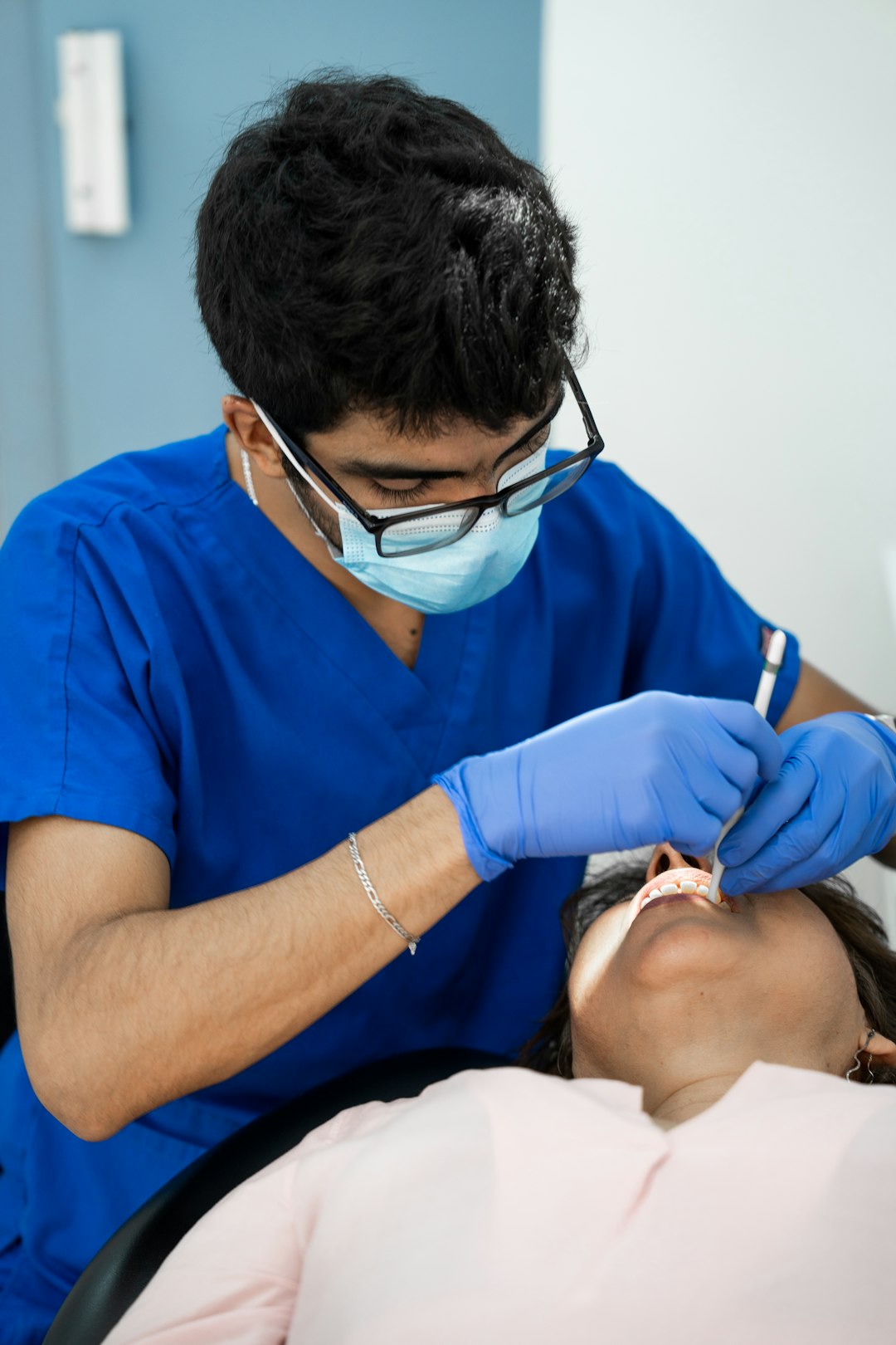 about-us-02 A dentist is providing medical treatment to a patient.